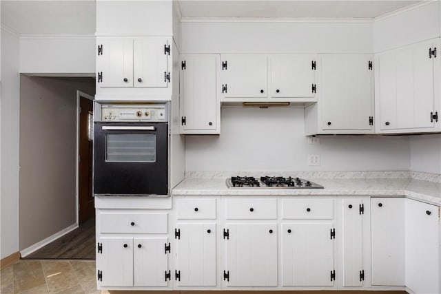 kitchen featuring white cabinetry, crown molding, wall oven, baseboards, and stainless steel gas cooktop