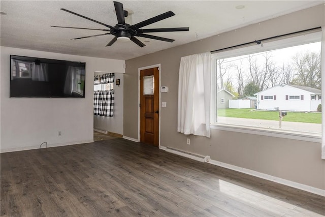 unfurnished living room featuring a ceiling fan, baseboards, wood finished floors, and a baseboard radiator