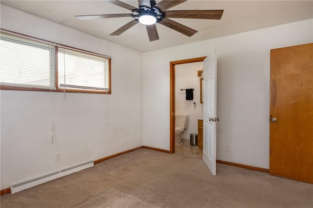 carpeted empty room with a baseboard heating unit, a ceiling fan, and baseboards