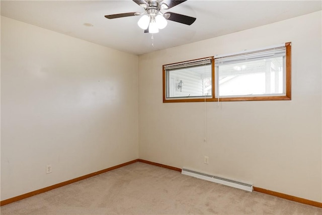 spare room with light colored carpet, a baseboard heating unit, and baseboards