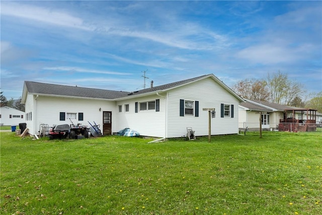 rear view of house with a yard