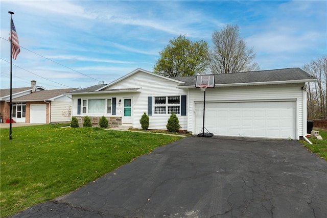 ranch-style house with a front lawn, driveway, and a garage