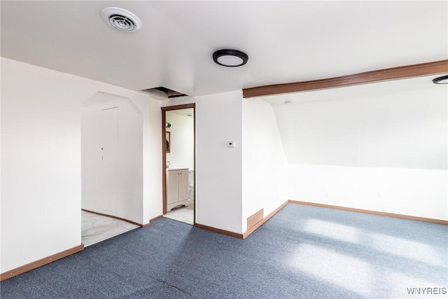spare room with visible vents, baseboards, and light colored carpet