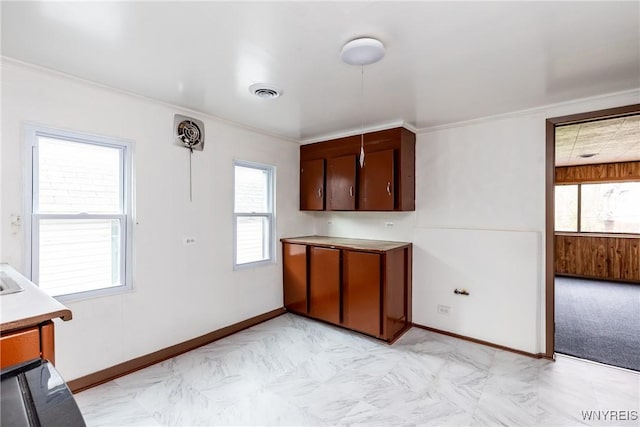 kitchen with light countertops, baseboards, visible vents, and marble finish floor