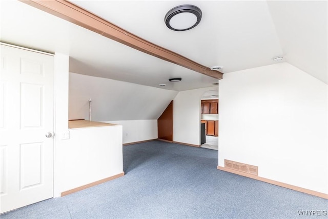 additional living space featuring carpet flooring, baseboards, vaulted ceiling, and visible vents