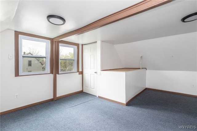 bonus room with carpet floors, baseboards, and lofted ceiling