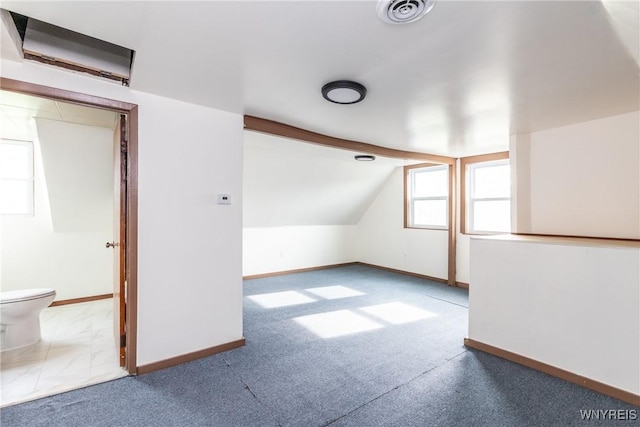 bonus room with carpet floors, baseboards, vaulted ceiling, and visible vents
