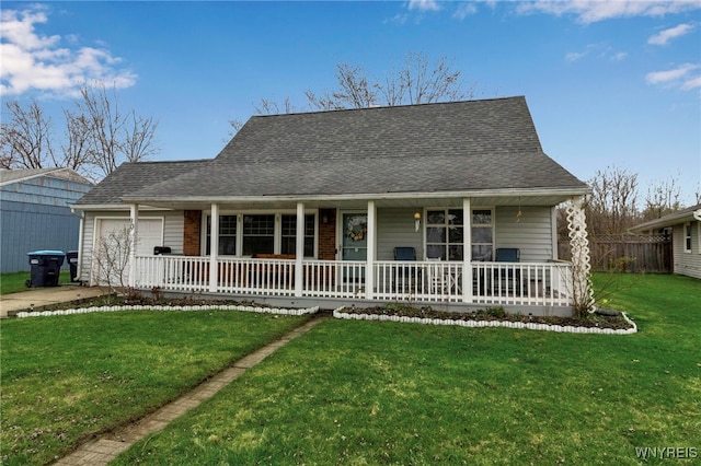 view of front facade with a porch, a front yard, an attached garage, and roof with shingles