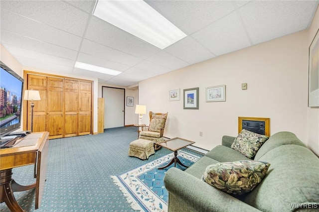 carpeted living room with baseboards and a paneled ceiling