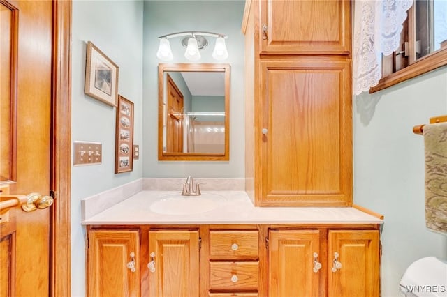 full bathroom with toilet and vanity