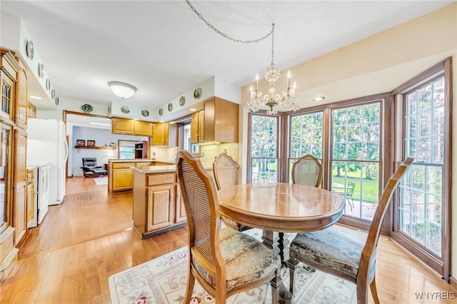 dining room with a chandelier and light wood-style floors