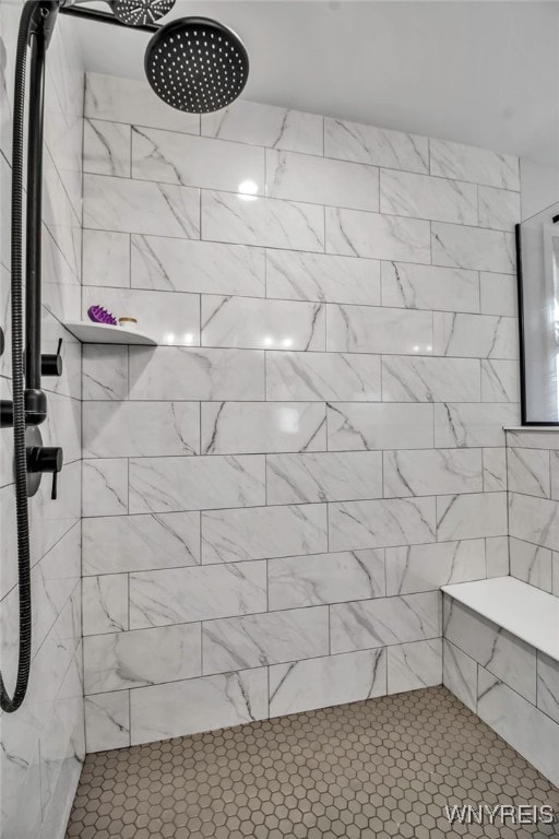 bathroom with a tile shower