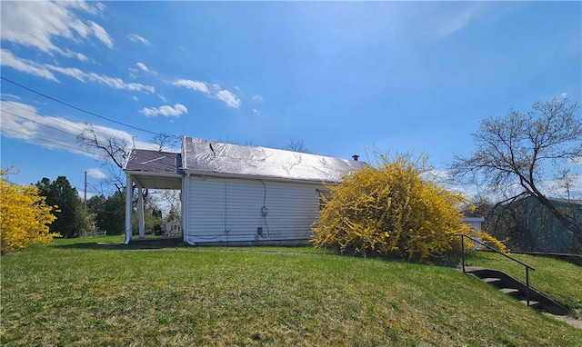 view of side of home with a lawn