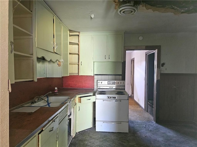 kitchen featuring concrete floors, dark countertops, backsplash, white range with electric stovetop, and a sink