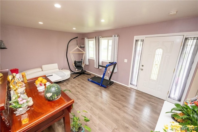 living area featuring baseboards, recessed lighting, and wood finished floors