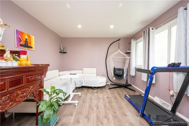 workout room featuring visible vents, light wood-style flooring, and recessed lighting