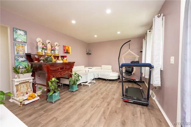 exercise area featuring baseboards, recessed lighting, and wood finished floors