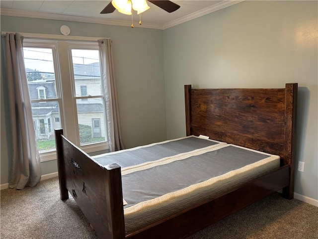 bedroom with ornamental molding, multiple windows, and carpet flooring