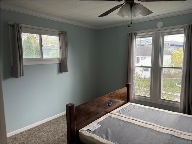 bedroom with crown molding, ceiling fan, carpet, and baseboards