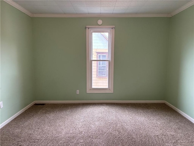 carpeted empty room with baseboards and ornamental molding