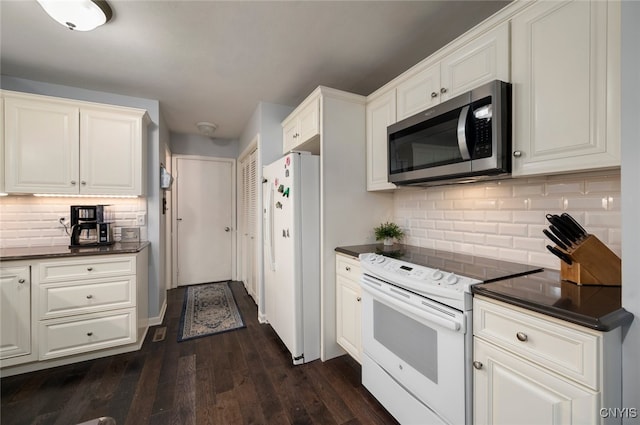 kitchen featuring dark wood-style floors, tasteful backsplash, white cabinetry, white appliances, and dark countertops