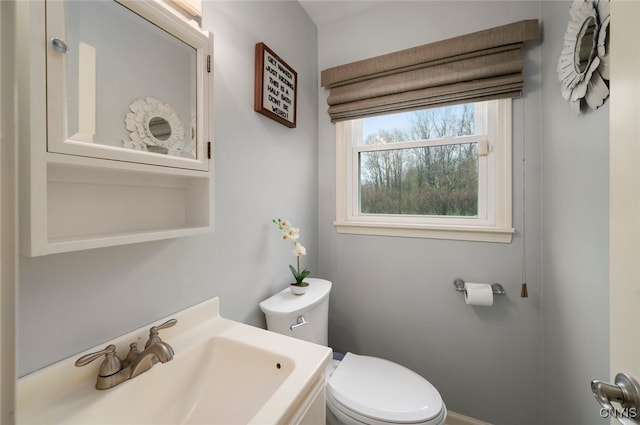bathroom featuring toilet and a sink