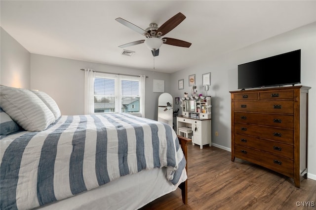 bedroom with baseboards, visible vents, wood finished floors, and a ceiling fan