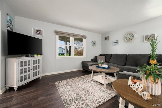 living area with wood finished floors and baseboards