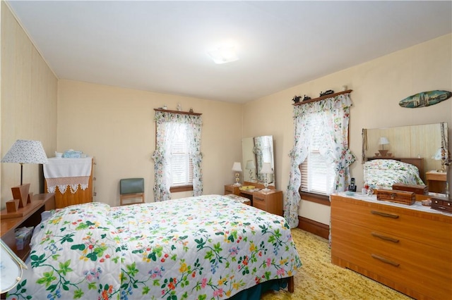 bedroom with baseboards and multiple windows