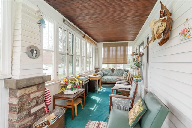 sunroom with carpet flooring and wooden ceiling