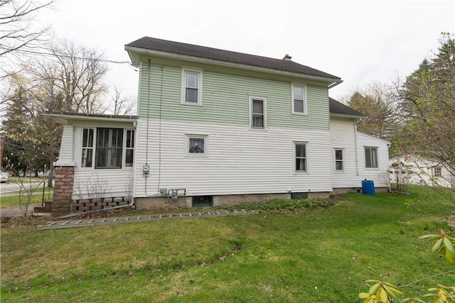 rear view of property featuring a yard