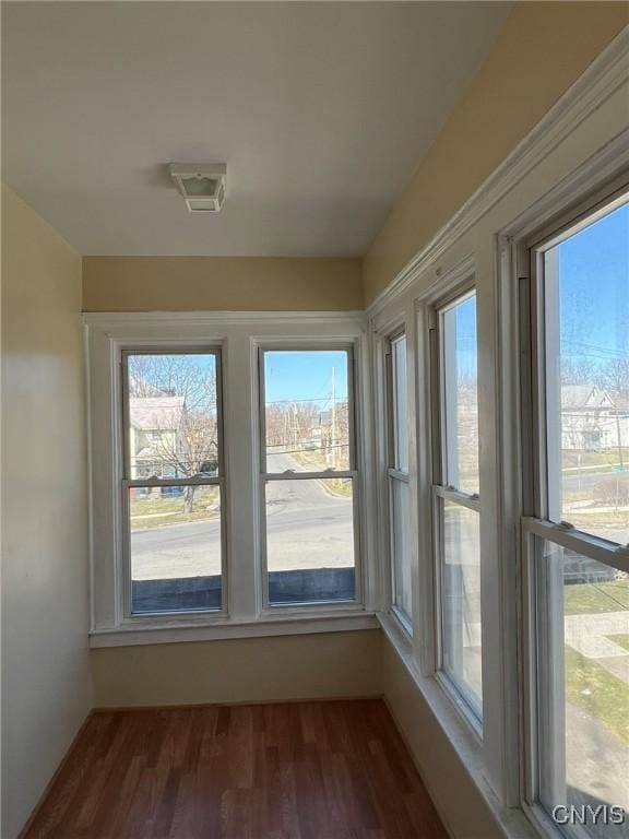 unfurnished sunroom with wood finished floors and visible vents