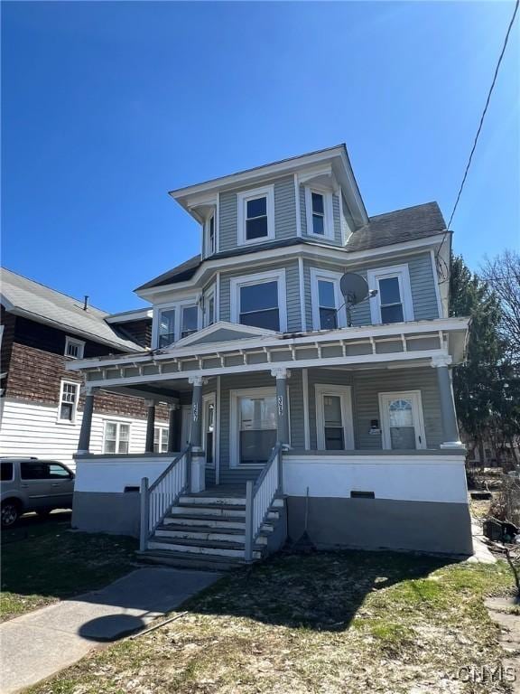 american foursquare style home featuring a porch