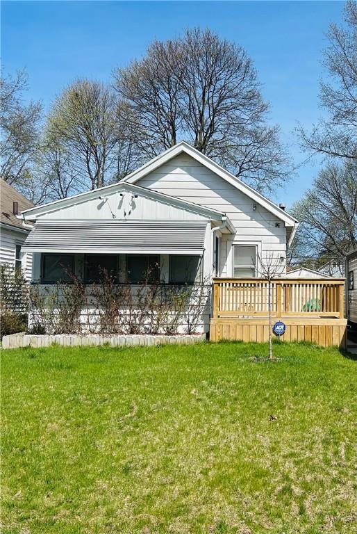 view of front facade featuring a front lawn and a deck