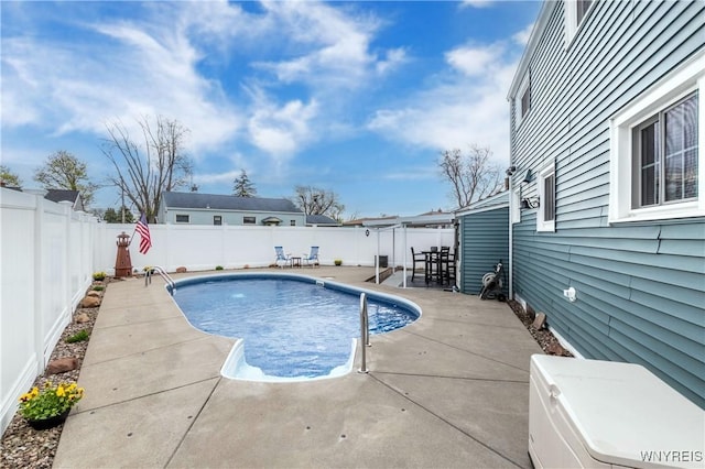 view of swimming pool featuring a fenced in pool, a patio area, and a fenced backyard