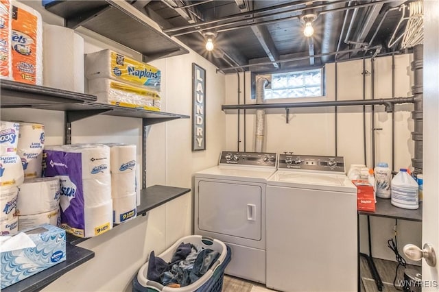clothes washing area with washing machine and clothes dryer and laundry area