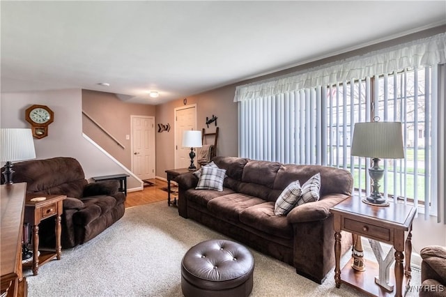 living area featuring stairway and wood finished floors