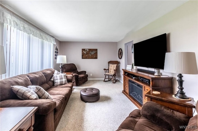 carpeted living area with baseboards