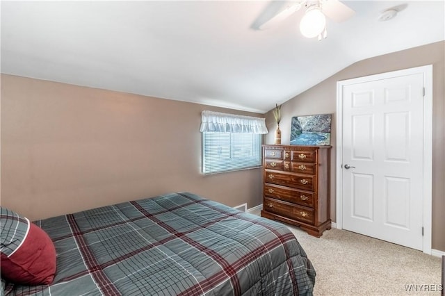 carpeted bedroom with baseboards, ceiling fan, and lofted ceiling