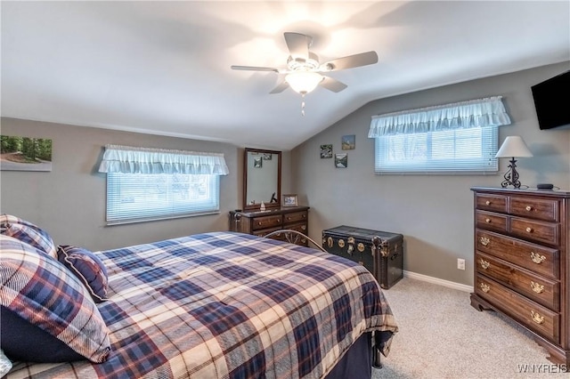 bedroom featuring a ceiling fan, baseboards, vaulted ceiling, and light carpet