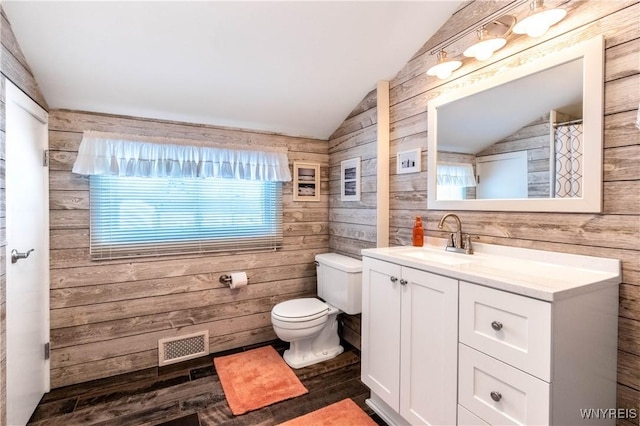 bathroom featuring wooden walls, visible vents, toilet, and vaulted ceiling