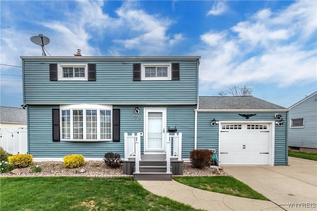 colonial home with a front yard, driveway, and an attached garage