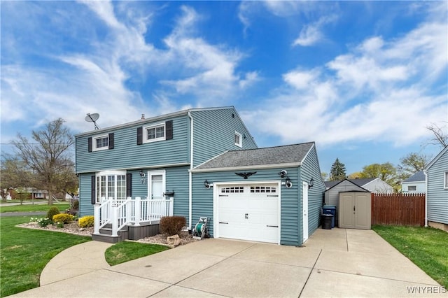 colonial-style house featuring driveway, a storage unit, a front yard, and a garage