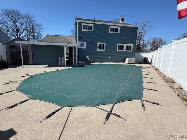 view of swimming pool with a fenced in pool, a fenced backyard, and a patio area