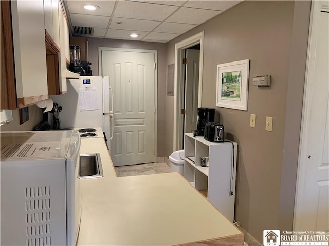 kitchen featuring recessed lighting, freestanding refrigerator, a drop ceiling, light countertops, and visible vents