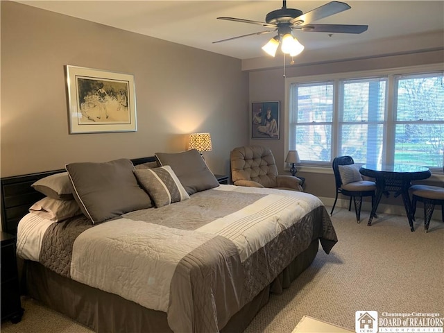 bedroom featuring a ceiling fan and light carpet