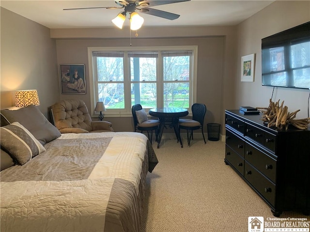 bedroom with ceiling fan and light colored carpet