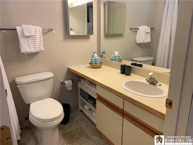 full bathroom with vanity and toilet