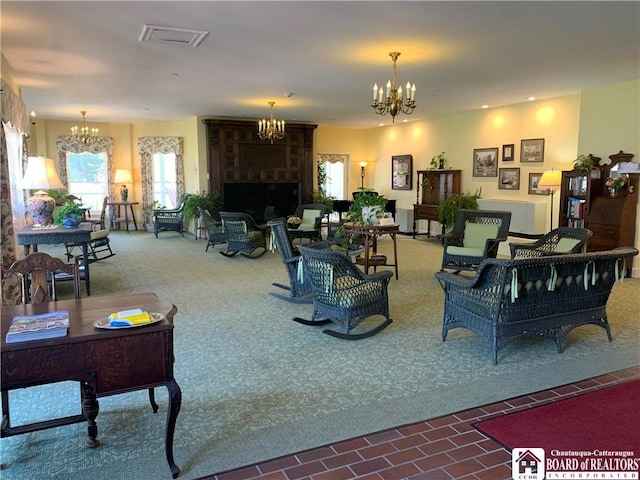 carpeted living room featuring an inviting chandelier, a fireplace, visible vents, and plenty of natural light