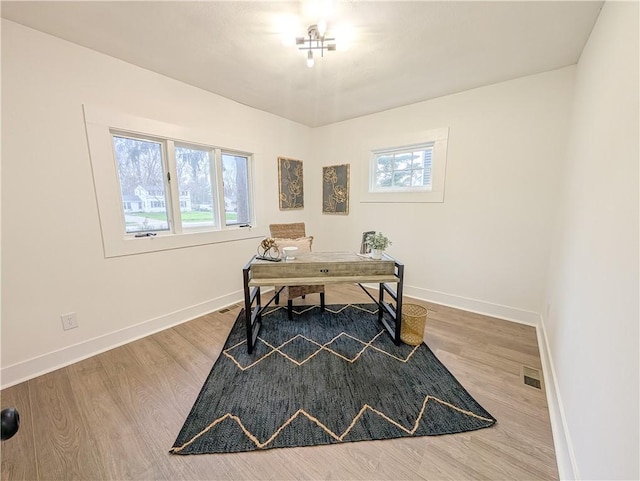 office featuring visible vents, a wealth of natural light, and baseboards